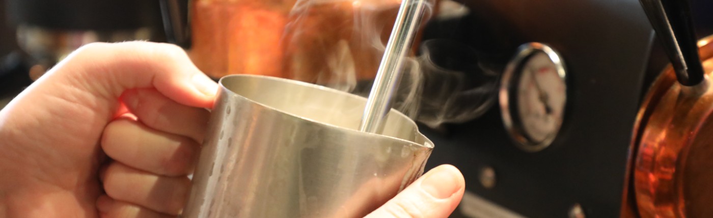 barista preparing a drink using a coffee machine